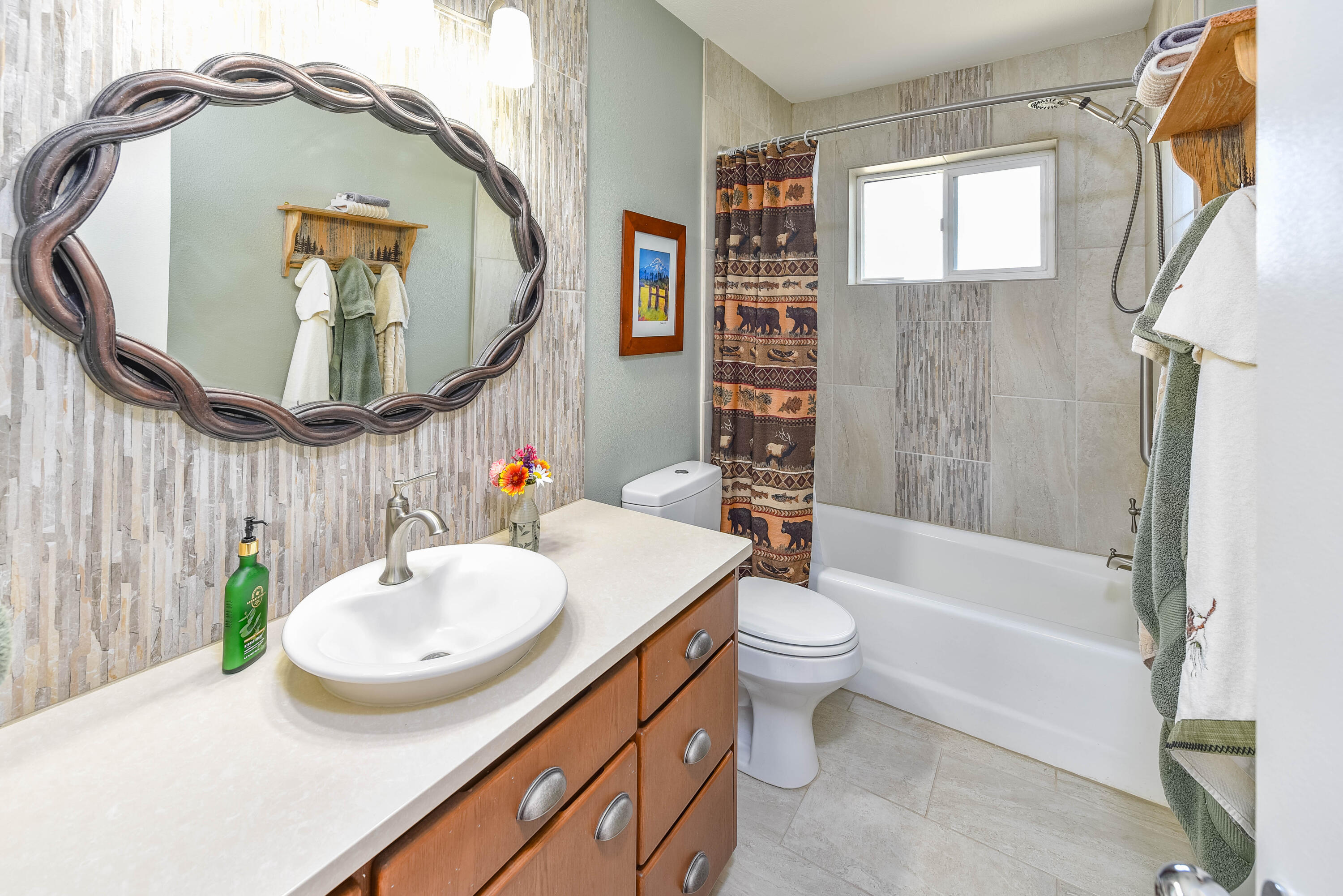 63475 Cricketwood Road Bend, OR 97701 - Photo 16 of 64 a bathroom with a sink a toilet and a mirror