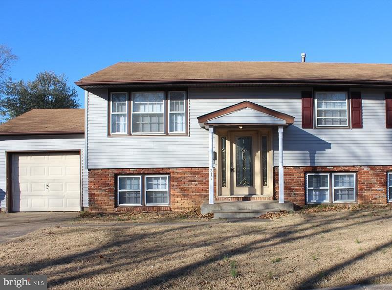 317 Overbrook Avenue Glassboro, NJ 08028 - Photo 1 of 11 a front view of a house with a garage