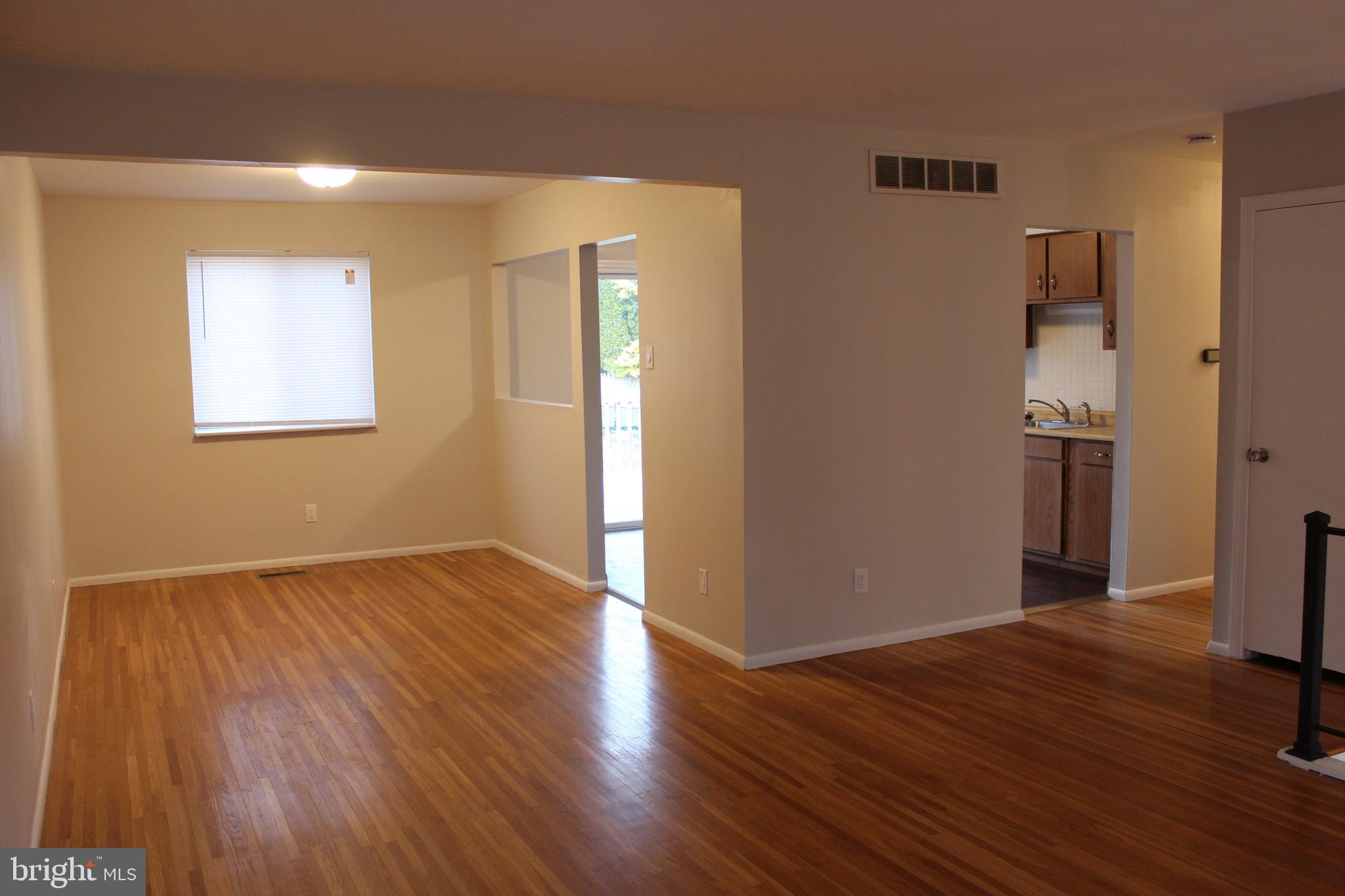 317 Overbrook Avenue Glassboro, NJ 08028 - Photo 4 of 11 a view of an empty room with wooden floor and a window