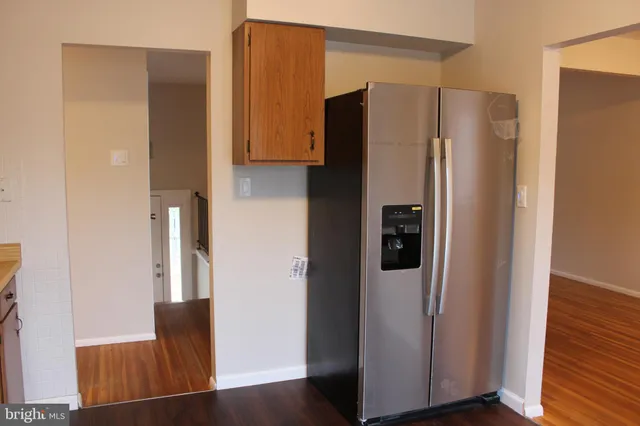 a metallic refrigerator freezer sitting in a kitchen