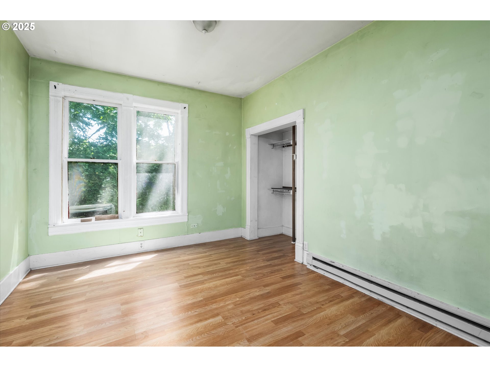 490 West 4th Avenue Eugene, OR 97401 - Photo 7 of 25 a view of an empty room with wooden floor and a window