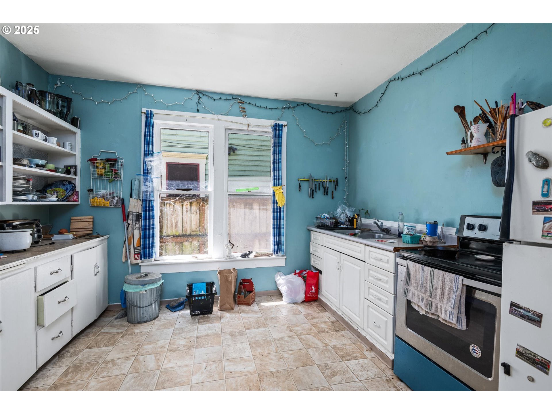 490 West 4th Avenue Eugene, OR 97401 - Photo 9 of 25 a kitchen that has a lot of cabinets in it and wooden floors