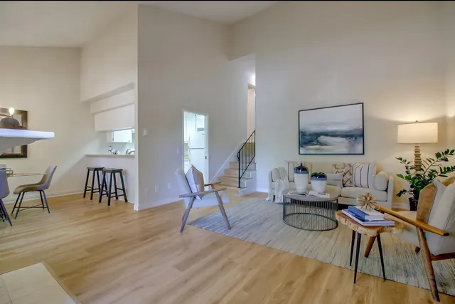 a living room with furniture and wooden floor