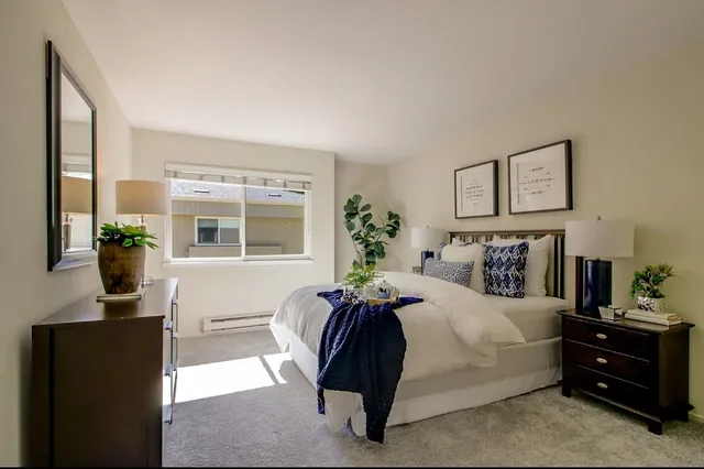 a bedroom with a large bed and a window