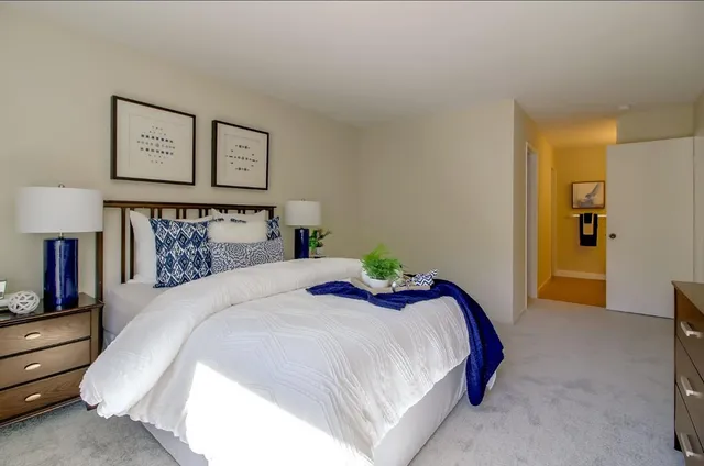 a bedroom with a bed and lamp