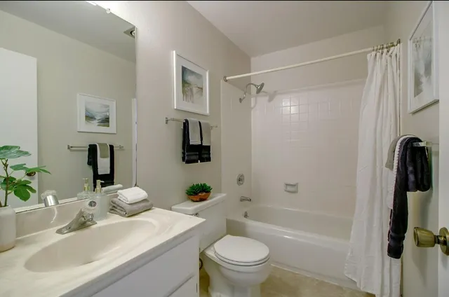 a bathroom with double vanity and a mirror