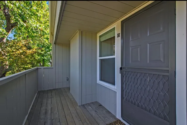 a view of a house with a wooden deck