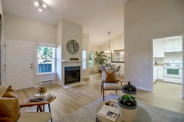 a living room with furniture a fireplace and wooden floor