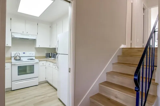 a kitchen with cabinets and a stove