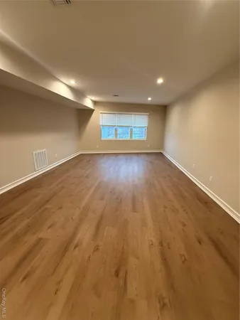 an empty room with a kitchen and windows