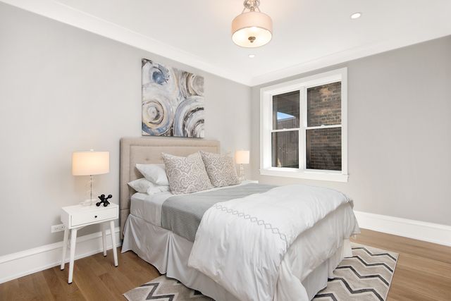 a bedroom with a large bed and a window