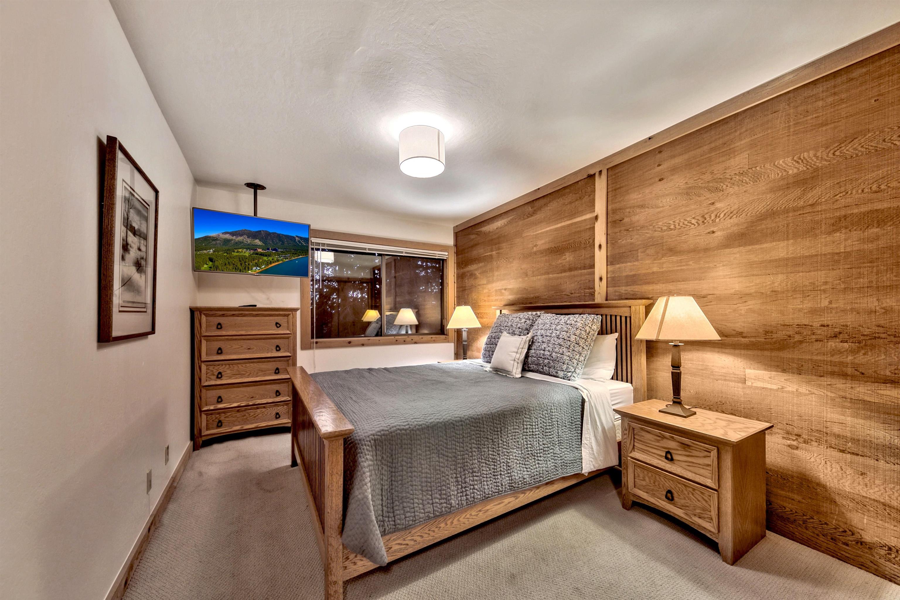 6004 Mill Camp Truckee, CA 96161 - Photo 14 of 21 a bedroom with a bed and a chandelier