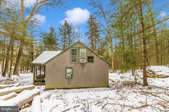a view of a house with a yard covered in snow