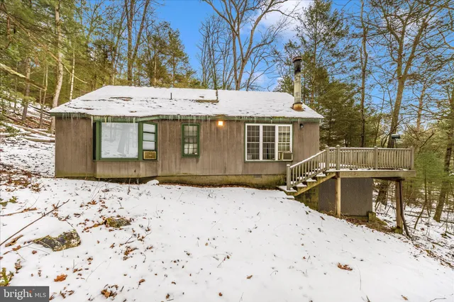 a view of a house with a snow in the yard