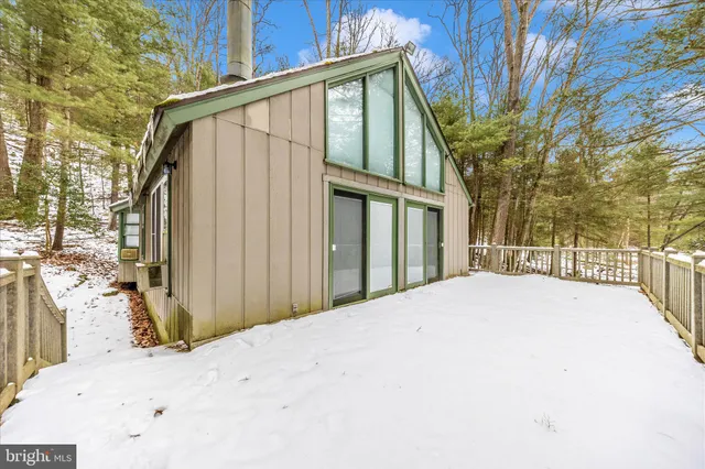 a view of a house with a wooden fence