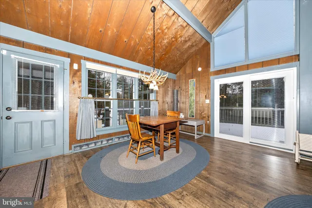 a living room with furniture a flat screen tv and a large window