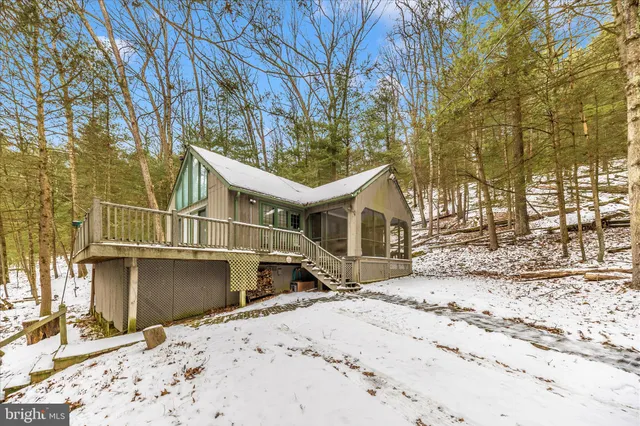 a view of a house with snow on the road