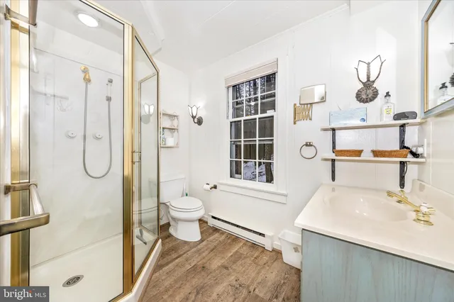 a bathroom with a shower a toilet and a shower