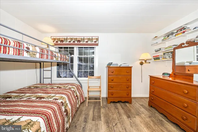 a view of a bedroom with a bed and a window