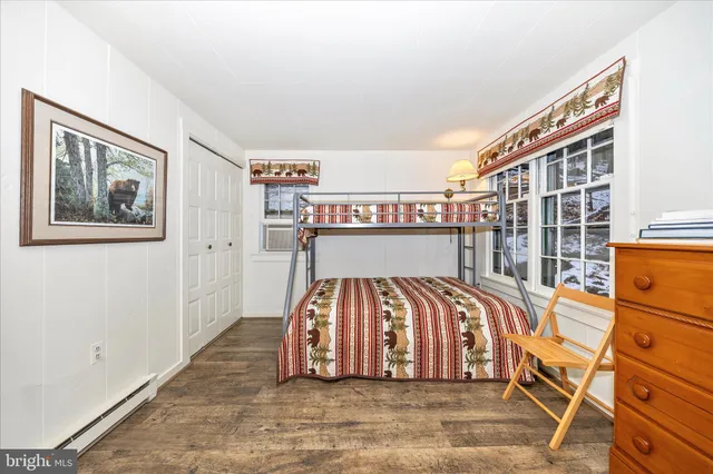a view of a porch with a bench and wooden fence