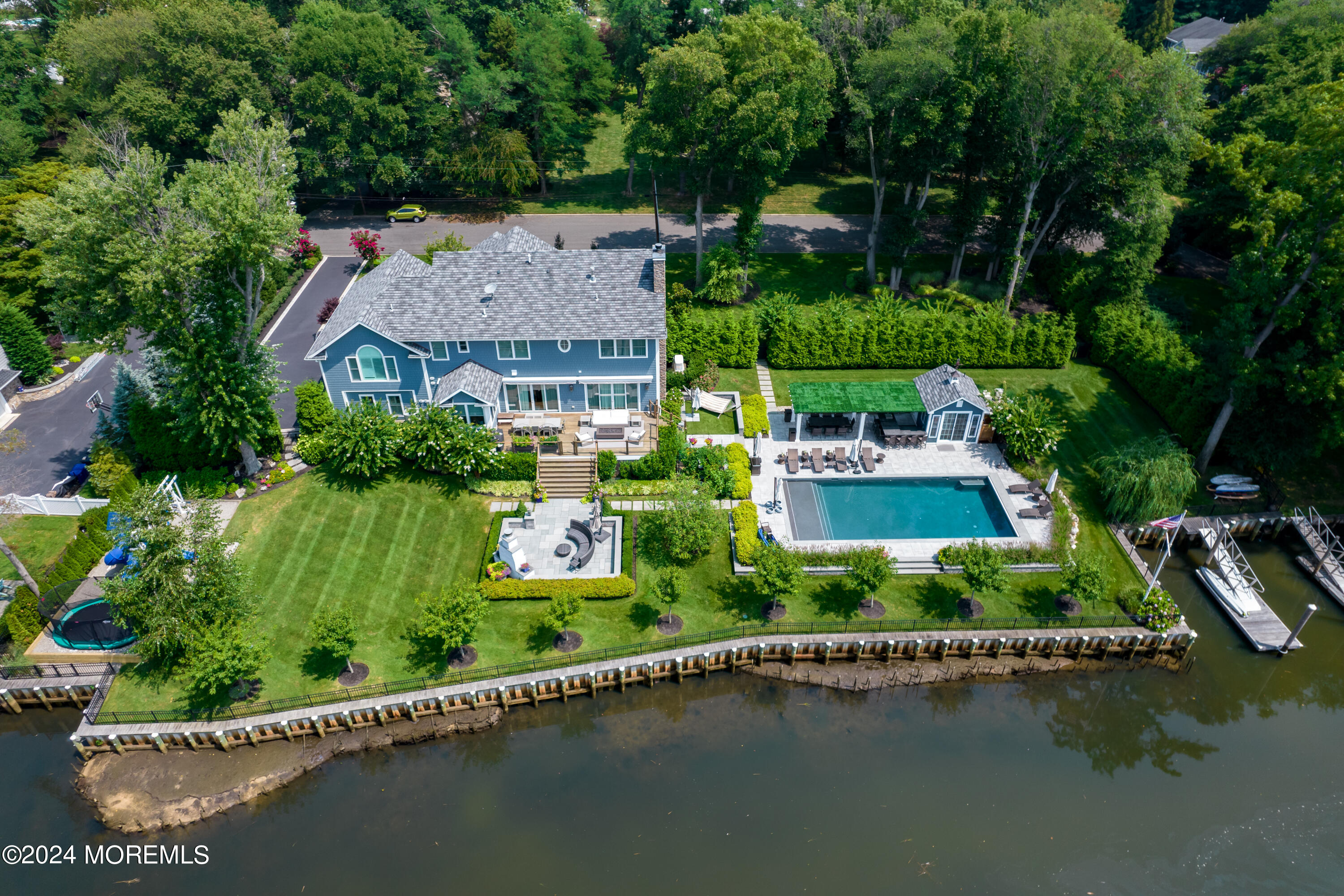an aerial view of a house with a garden and lake view