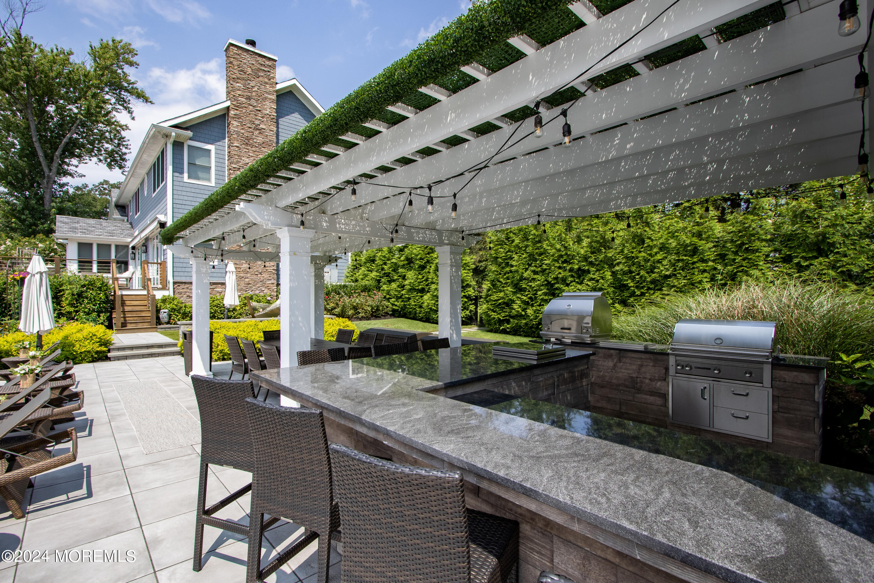 15 Mitchell Place Little Silver, NJ 07739 - Photo 33 of 39 a view of a patio with table and chairs potted plants and palm tree