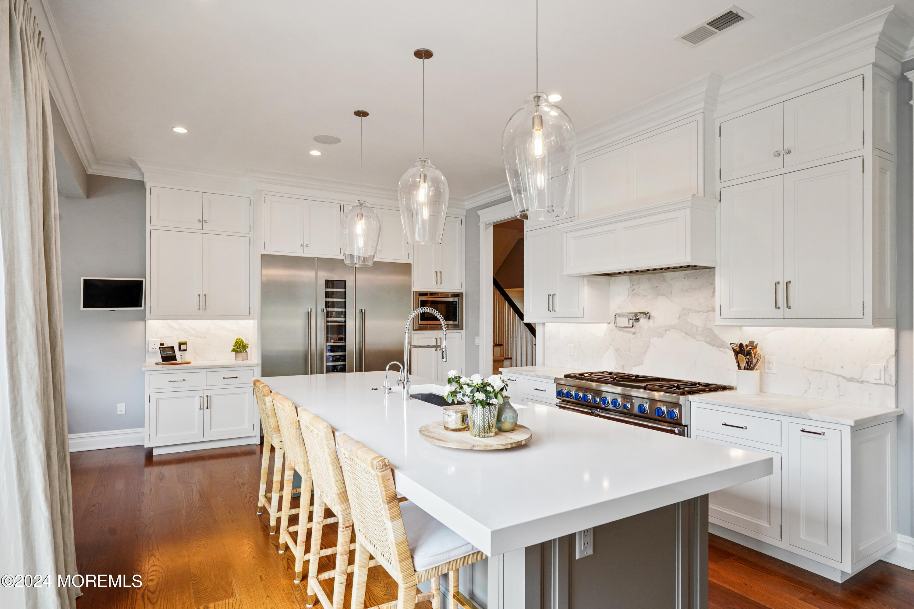 15 Mitchell Place Little Silver, NJ 07739 - Photo 10 of 39 a kitchen with stainless steel appliances a stove a sink a kitchen island and chairs