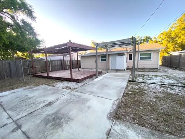 a backyard of a house with table and chairs