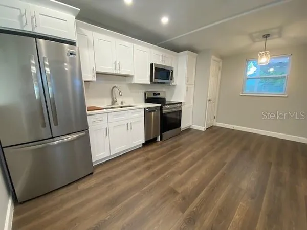a kitchen with stainless steel appliances granite countertop a refrigerator stove a sink and dishwasher