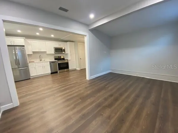 a kitchen with stainless steel appliances a refrigerator and a stove top oven