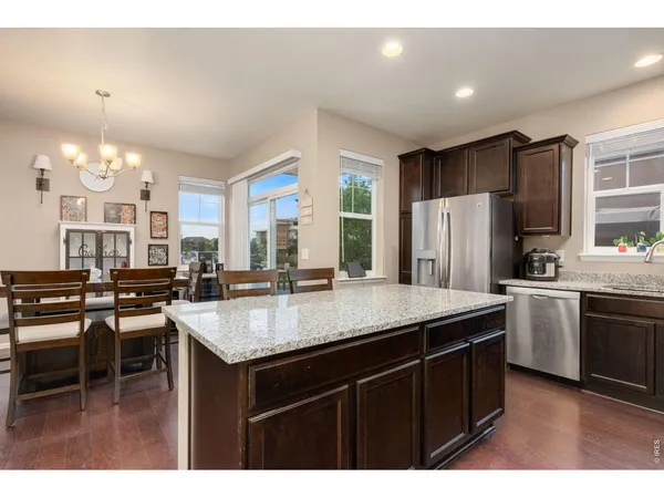 a kitchen with kitchen island a sink and a wooden cabinets