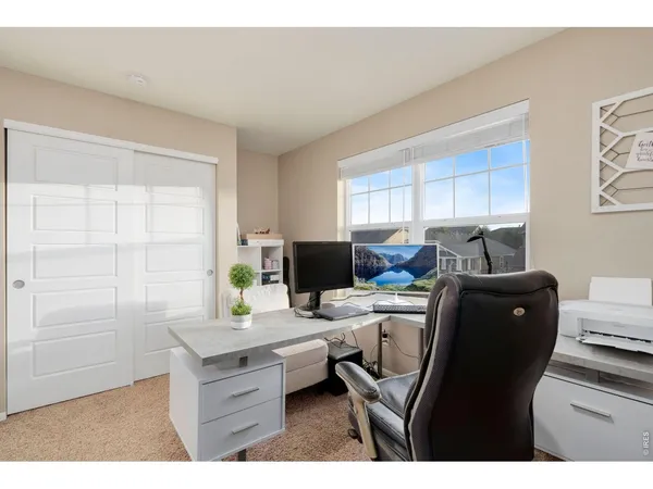 a living room with furniture a air conditioner vent and a table