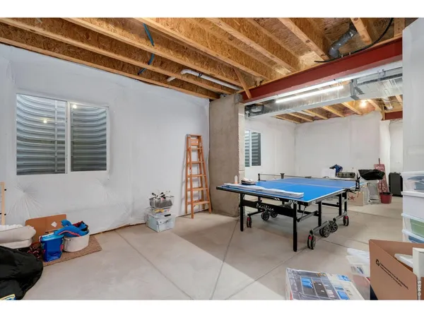 a living room with furniture a table tennis table and a rug