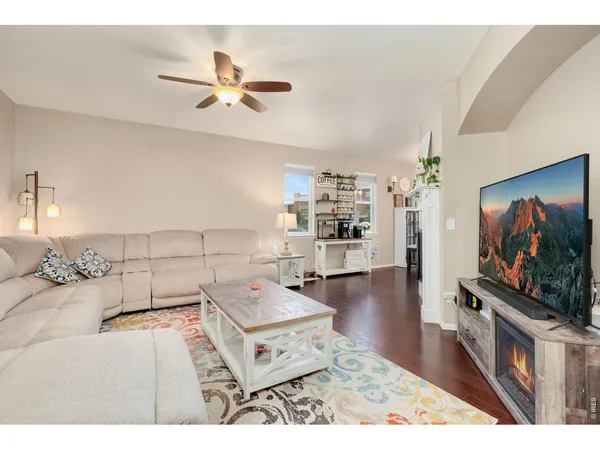 a living room with furniture and a chandelier