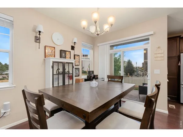 a view of a dining room with furniture and chandelier