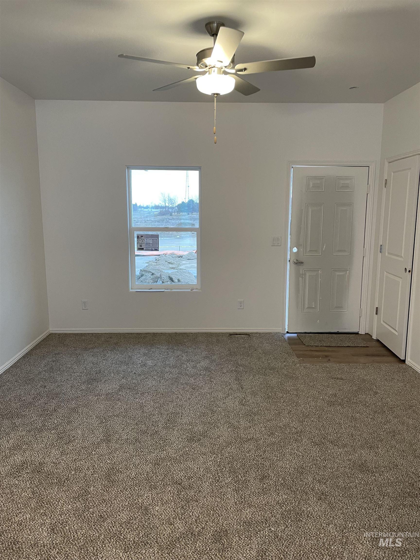937 Roen Road Jerome, ID 83338 - Photo 3 of 4 Carpeted spare room featuring ceiling fan and baseboards