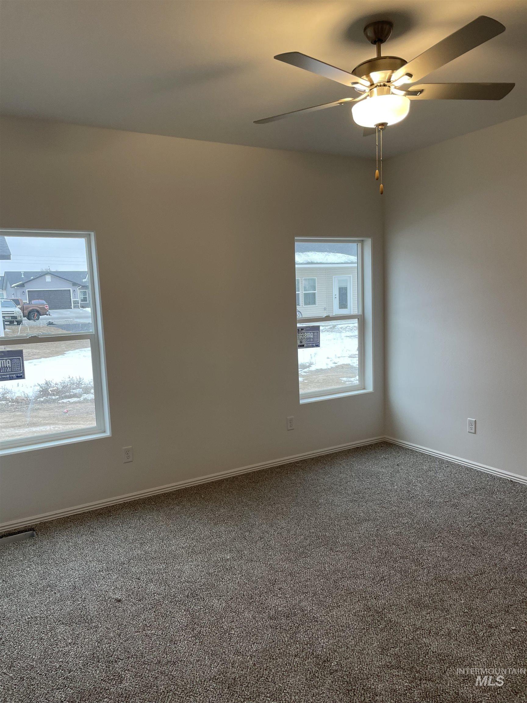 937 Roen Road Jerome, ID 83338 - Photo 4 of 4 Empty room featuring a ceiling fan and carpet