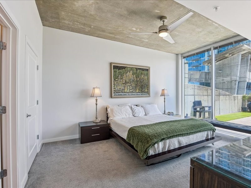 5925 Almeda Road, Unit 10714 Houston, TX 77004 - Photo 12 of 38 a bedroom with a bed couch and a window