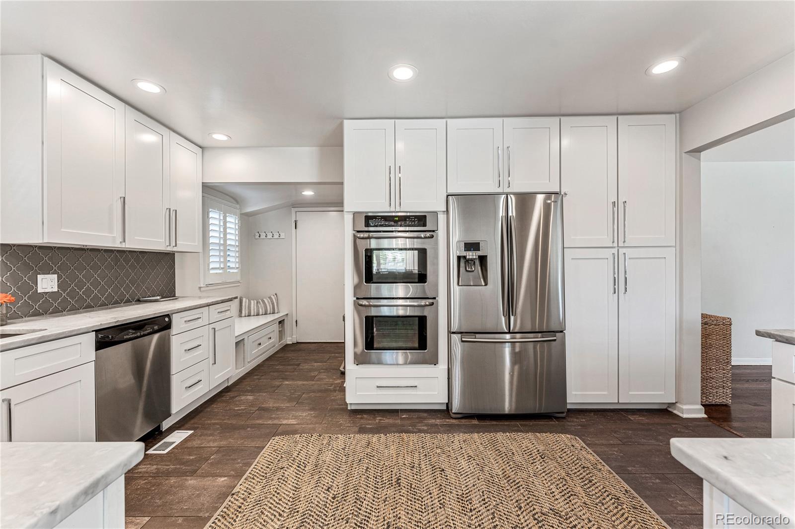 3800 East Dartmouth Avenue Denver, CO 80210 - Photo 12 of 50 a kitchen with granite countertop a refrigerator and a stove top oven