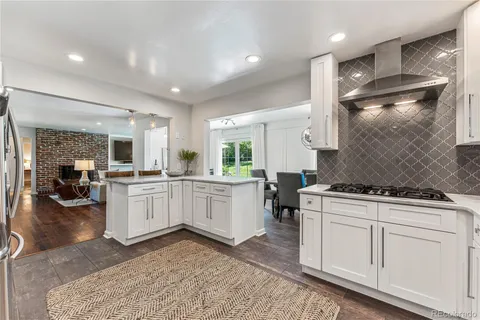 a kitchen with a stove and white cabinets