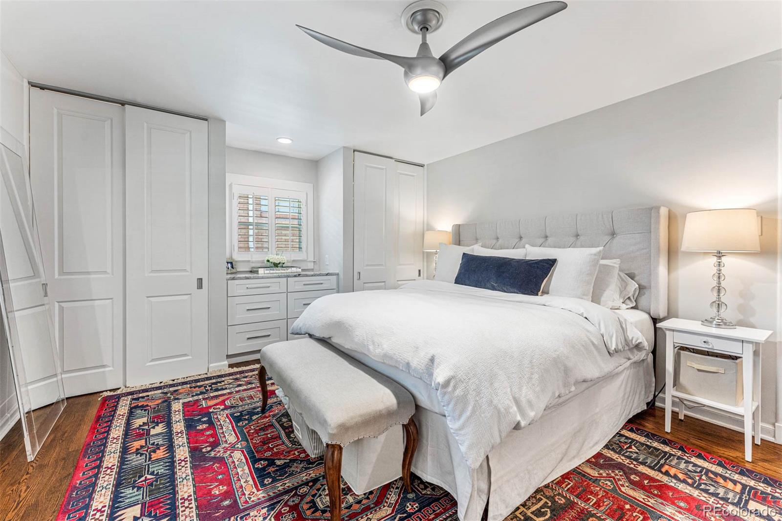 3800 East Dartmouth Avenue Denver, CO 80210 - Photo 18 of 50 a bedroom with a bed and a lamp on a dresser