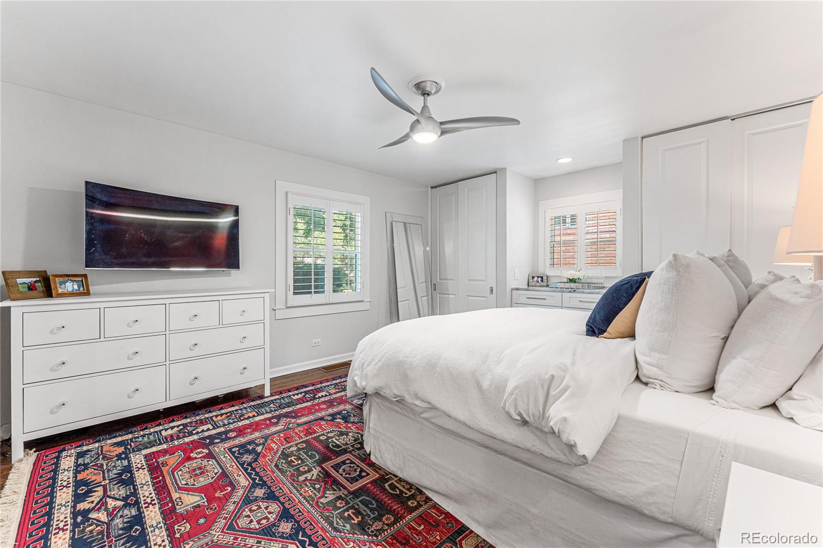 3800 East Dartmouth Avenue Denver, CO 80210 - Photo 20 of 50 a bedroom with a bed and a flat screen tv