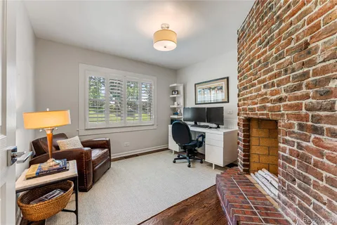 a view of a workspace with furniture and a window