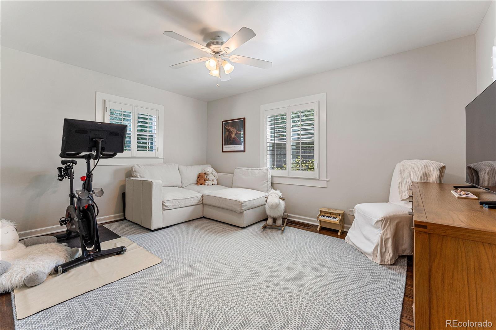 3800 East Dartmouth Avenue Denver, CO 80210 - Photo 24 of 50 a bedroom with furniture and a flat screen tv