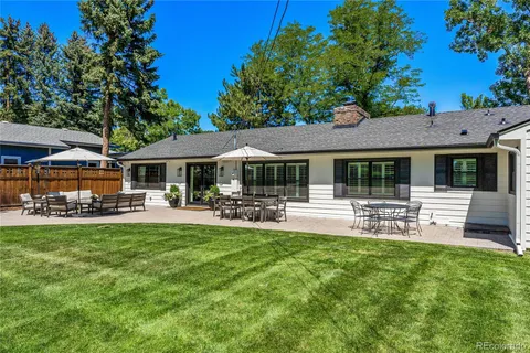 a front view of a house with swimming pool and sitting area