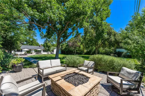 a view of a patio with couches chairs and a yard
