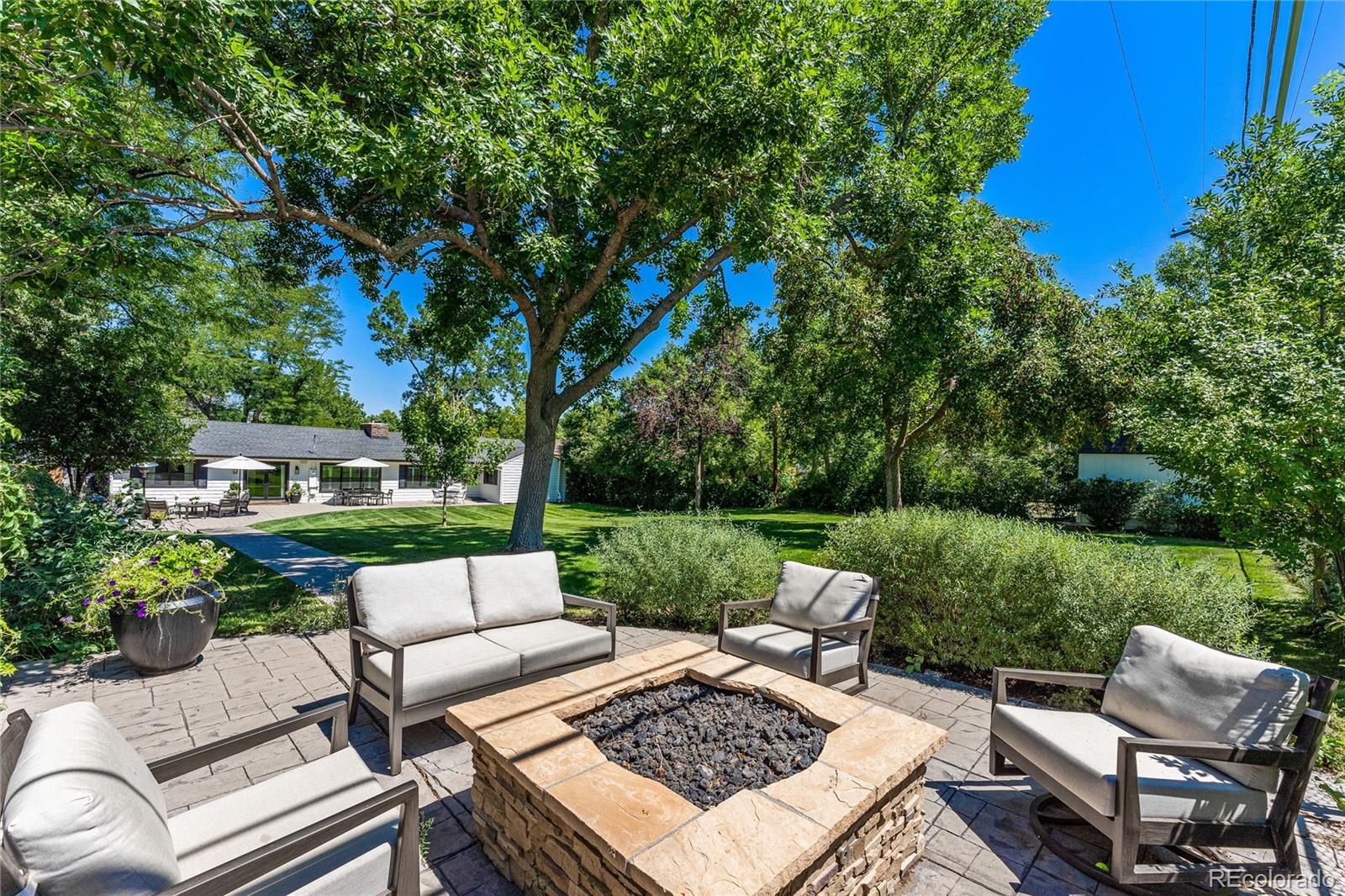 3800 East Dartmouth Avenue Denver, CO 80210 - Photo 38 of 50 a view of a patio with couches chairs and a yard