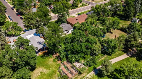 an aerial view of residential house with outdoor space and trees all around