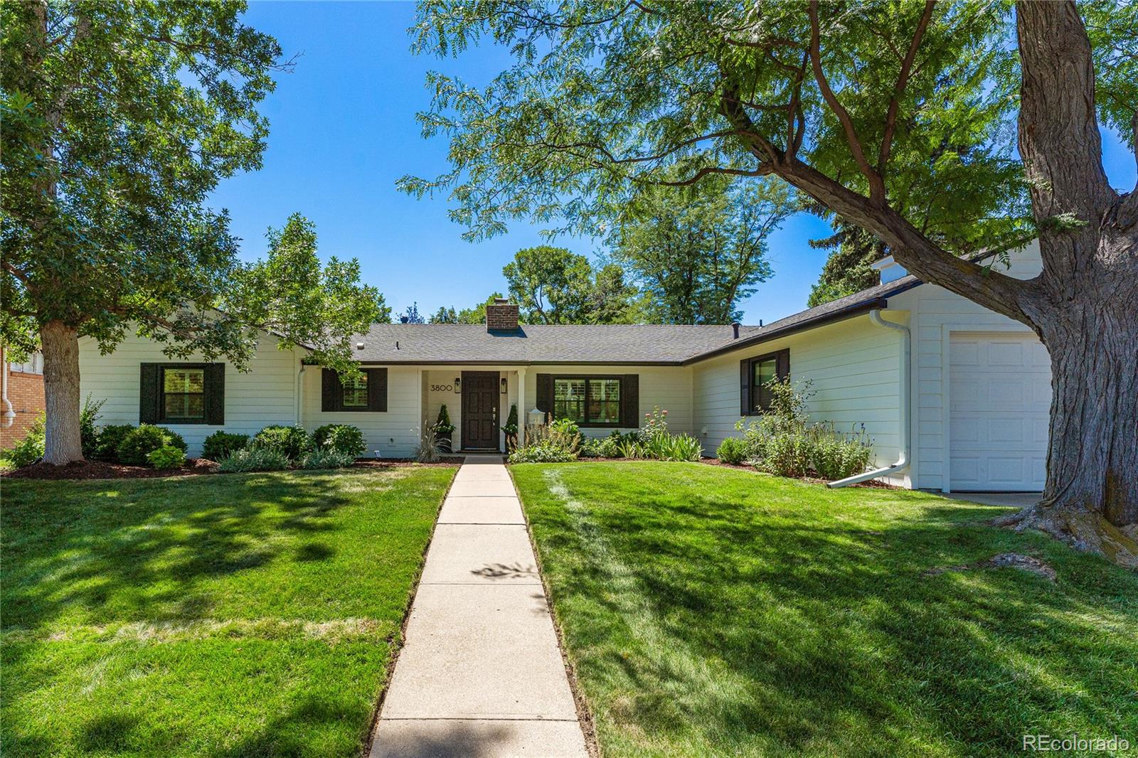 3800 East Dartmouth Avenue Denver, CO 80210 - Photo 49 of 50 a front view of house with yard and green space