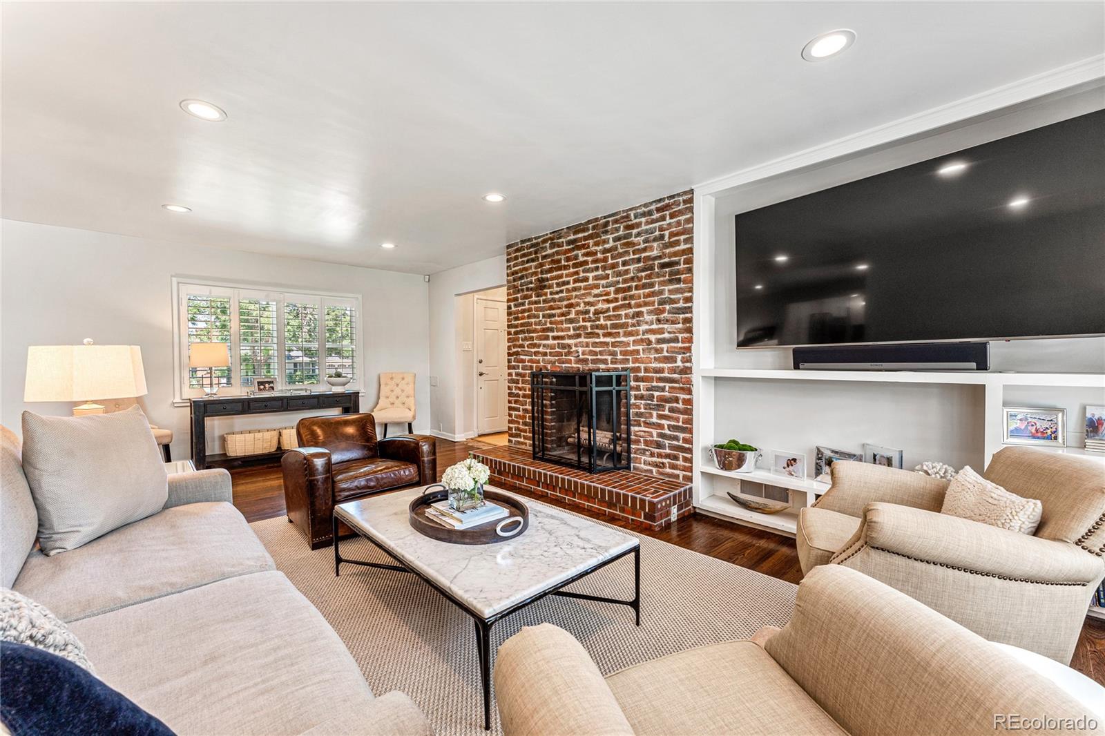 3800 East Dartmouth Avenue Denver, CO 80210 - Photo 6 of 50 a living room with furniture and a flat screen tv
